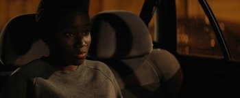 Movie still from “Girlhood” (2014), directed by Céline Sciamma – A person sitting in a car with a dark background; Close Up shot, Over the shoulder angle