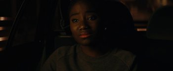 Movie still from “Girlhood” (2014), directed by Céline Sciamma – A young woman is sitting in a dark room; Close Up shot, Over the shoulder angle