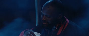 Movie still from “Girlhood” (2014), directed by Céline Sciamma – A person wearing headphones and holding a cup; Close Up shot, Low angle