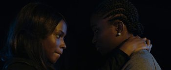 Movie still from “Girlhood” (2014), directed by Céline Sciamma – Two women looking at each other in the dark; Close Up shot, Over the shoulder angle