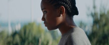 Movie still from “Girlhood” (2014), directed by Céline Sciamma – A person wearing a gray shirt; Close Up shot, Low angle