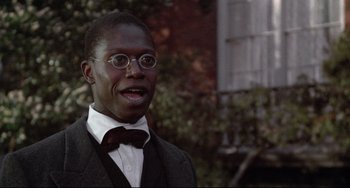 Movie still from “Glory” (1989), directed by Edward Zwick – A man wearing a suit and bow tie; Close Up shot, Over the shoulder angle