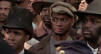 Movie still from “Glory” (1989), directed by Edward Zwick – A group of men wearing hats and coats; Close Up shot, Low angle