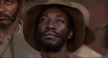 Movie still from “Glory” (1989), directed by Edward Zwick – A person wearing a hat; Close Up shot, Low angle