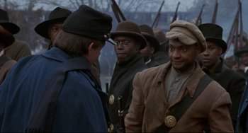 Movie still from “Glory” (1989), directed by Edward Zwick – A group of men standing next to each other holding guns; Close Up shot, Over the shoulder angle