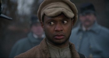 Movie still from “Glory” (1989), directed by Edward Zwick – A person wearing a hat; Close Up shot, Over the shoulder angle
