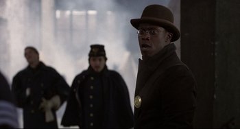 Movie still from “Glory” (1989), directed by Edward Zwick – A man wearing a hat and a coat; Close Up shot, Over the shoulder angle