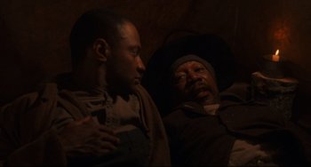 Movie still from “Glory” (1989), directed by Edward Zwick – Two men sitting next to each other in a dark room; Close Up shot, High angle