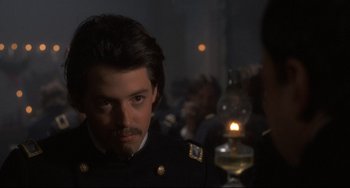 Movie still from “Glory” (1989), directed by Edward Zwick – A person wearing a uniform near a candle; Close Up shot, Over the shoulder angle