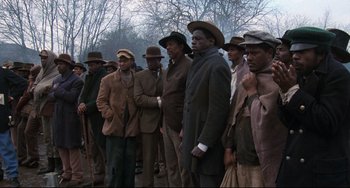 Movie still from “Glory” (1989), directed by Edward Zwick – A group of men standing next to each other on a street; Medium shot, Low angle