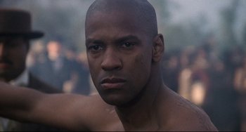 Movie still from “Glory” (1989), directed by Edward Zwick – A man's face in a crowd; Close Up shot, Low angle