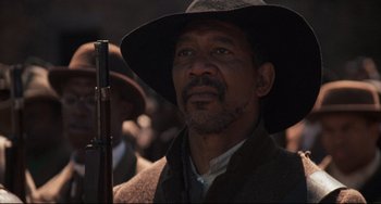 Movie still from “Glory” (1989), directed by Edward Zwick – A man with a hat holding a rifle; Close Up shot, Low angle
