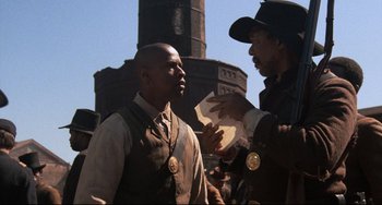 Movie still from “Glory” (1989), directed by Edward Zwick – Two men are standing in front of each other; Medium shot, Over the shoulder angle