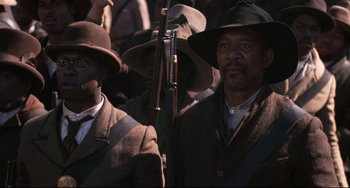 Movie still from “Glory” (1989), directed by Edward Zwick – A group of men standing next to each other holding guns; Close Up shot, Low angle