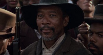 Movie still from “Glory” (1989), directed by Edward Zwick – An older man wearing a hat and a suit; Close Up shot, Low angle