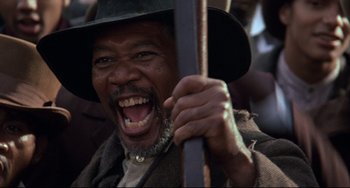 Movie still from “Glory” (1989), directed by Edward Zwick – An older man wearing a hat and holding a stick; Close Up shot, Low angle
