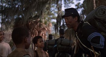 Movie still from “Glory” (1989), directed by Edward Zwick – A group of people standing next to each other on a field; Medium shot, Over the shoulder angle