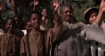 Movie still from “Glory” (1989), directed by Edward Zwick – A group of young men standing next to each other in front of a tree; Medium shot, Low angle