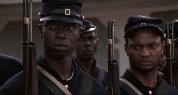 Movie still from “Glory” (1989), directed by Edward Zwick – A group of men in civil war uniforms holding rifles; Close Up shot, Over the shoulder angle