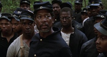 Movie still from “Glory” (1989), directed by Edward Zwick – A group of men in black uniforms and black hats; Close Up shot, High angle