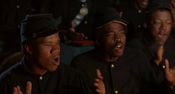 Movie still from “Glory” (1989), directed by Edward Zwick – A couple of people that are singing together; Close Up shot, Low angle