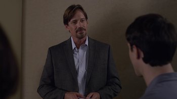 Movie still from “God's Not Dead” (2014), directed by Harold Cronk – A man wearing a suit and tie in front of a mirror; Close Up shot, Over the shoulder angle