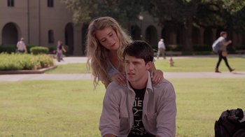 Movie still from “God's Not Dead” (2014), directed by Harold Cronk – A man and a woman sitting on the grass; Medium shot, Over the shoulder angle