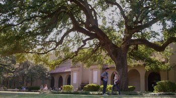 Movie still from “God's Not Dead” (2014), directed by Harold Cronk – A man and a woman standing next to a large tree; Extreme Wide shot, Low angle