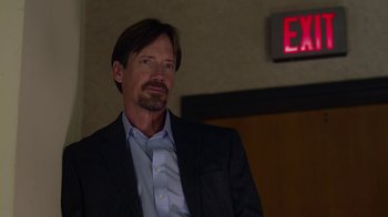 Movie still from “God's Not Dead” (2014), directed by Harold Cronk – A person wearing a suit and tie; Medium shot, Over the shoulder angle