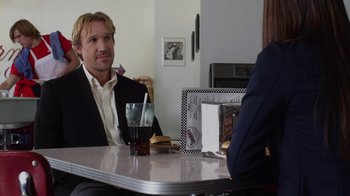 Movie still from “God's Not Dead” (2014), directed by Harold Cronk – A man sitting at a table in front of another man; Medium shot, Over the shoulder angle