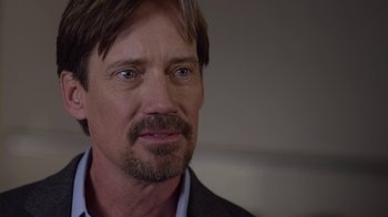 Movie still from “God's Not Dead” (2014), directed by Harold Cronk – A person wearing a suit and tie; Close Up shot, Over the shoulder angle