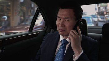 Movie still from “God's Not Dead” (2014), directed by Harold Cronk – A man in a suit and tie talking on a cell phone; Close Up shot, Over the shoulder angle