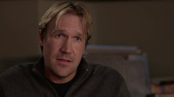 Movie still from “God's Not Dead” (2014), directed by Harold Cronk – A person sitting in a chair wearing a sweater; Close Up shot, Over the shoulder angle