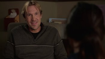 Movie still from “God's Not Dead” (2014), directed by Harold Cronk – A person sitting on a couch; Close Up shot, Over the shoulder angle