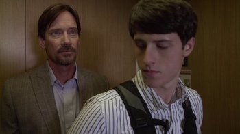 Movie still from “God's Not Dead” (2014), directed by Harold Cronk – A man standing next to another man in a suit; Close Up shot, Over the shoulder angle