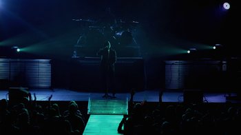 Movie still from “God's Not Dead” (2014), directed by Harold Cronk – A man standing on a stage in front of an audience; Extreme Wide shot, High angle