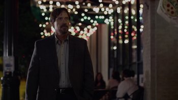 Movie still from “God's Not Dead” (2014), directed by Harold Cronk – A man in a suit standing in front of lights; Medium shot, Over the shoulder angle