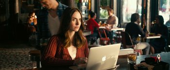 A woman sitting in front of an open laptop computer