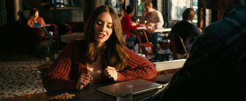 Movie still from “How to Be Single” (2016), directed by Christian Ditter – A woman sitting in front of a laptop computer at a table; Medium shot, Over the shoulder angle