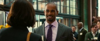 Movie still from “How to Be Single” (2016), directed by Christian Ditter – A man wearing a suit and tie smiling for a photo; Close Up shot, Over the shoulder angle