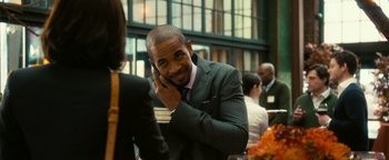 Movie still from “How to Be Single” (2016), directed by Christian Ditter – A man talking on a cell phone while sitting at a table; Medium shot, Over the shoulder angle