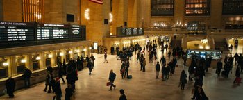Movie still from “How to Be Single” (2016), directed by Christian Ditter – A crowd of people walking around a train station at night; Extreme Wide shot, High angle