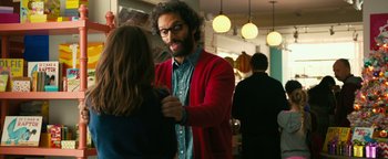 Movie still from “How to Be Single” (2016), directed by Christian Ditter – A man with a beard and a red cardigan is talking to a woman in a restaurant; Medium shot, Over the shoulder angle