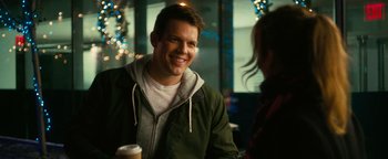 Movie still from “How to Be Single” (2016), directed by Christian Ditter – A man smiling while holding a cup of coffee; Close Up shot, Over the shoulder angle