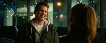 Movie still from “How to Be Single” (2016), directed by Christian Ditter – A man in a green jacket smiling for the camera; Close Up shot, Over the shoulder angle