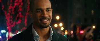 Movie still from “How to Be Single” (2016), directed by Christian Ditter – A person wearing a suit and smiling; Close Up shot, Over the shoulder angle
