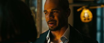 Movie still from “How to Be Single” (2016), directed by Christian Ditter – A person wearing a suit and tie; Close Up shot, Over the shoulder angle