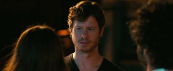 Movie still from “How to Be Single” (2016), directed by Christian Ditter – A person wearing a black t - shirt; Close Up shot, Over the shoulder angle