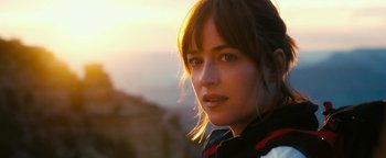 Movie still from “How to Be Single” (2016), directed by Christian Ditter – A person wearing a jacket with mountains in the background; Close Up shot, Low angle