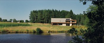 Movie still from “Goodnight Mommy” (2014), directed by Severin Fiala – A house sitting next to a body of water; Extreme Wide shot, Low angle